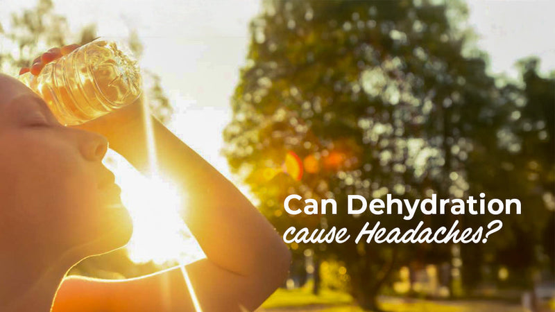 A woman pressing a cold water bottle to her forehead in bright sunlight, with text asking "Can Dehydration cause Headaches?"