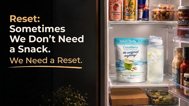 not an ad  An open refrigerator sits next to text that reads: "Reset: Sometimes We Don’t Need a Snack. We Need a Reset." Inside the fridge, a pouch of "CocoBana" drink mix and a water bottle with lemon slices are prominently displayed on a shelf.